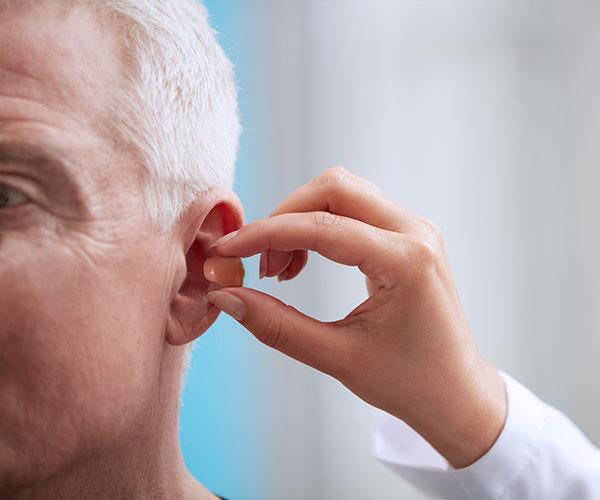 Audiologist fitting client CIC